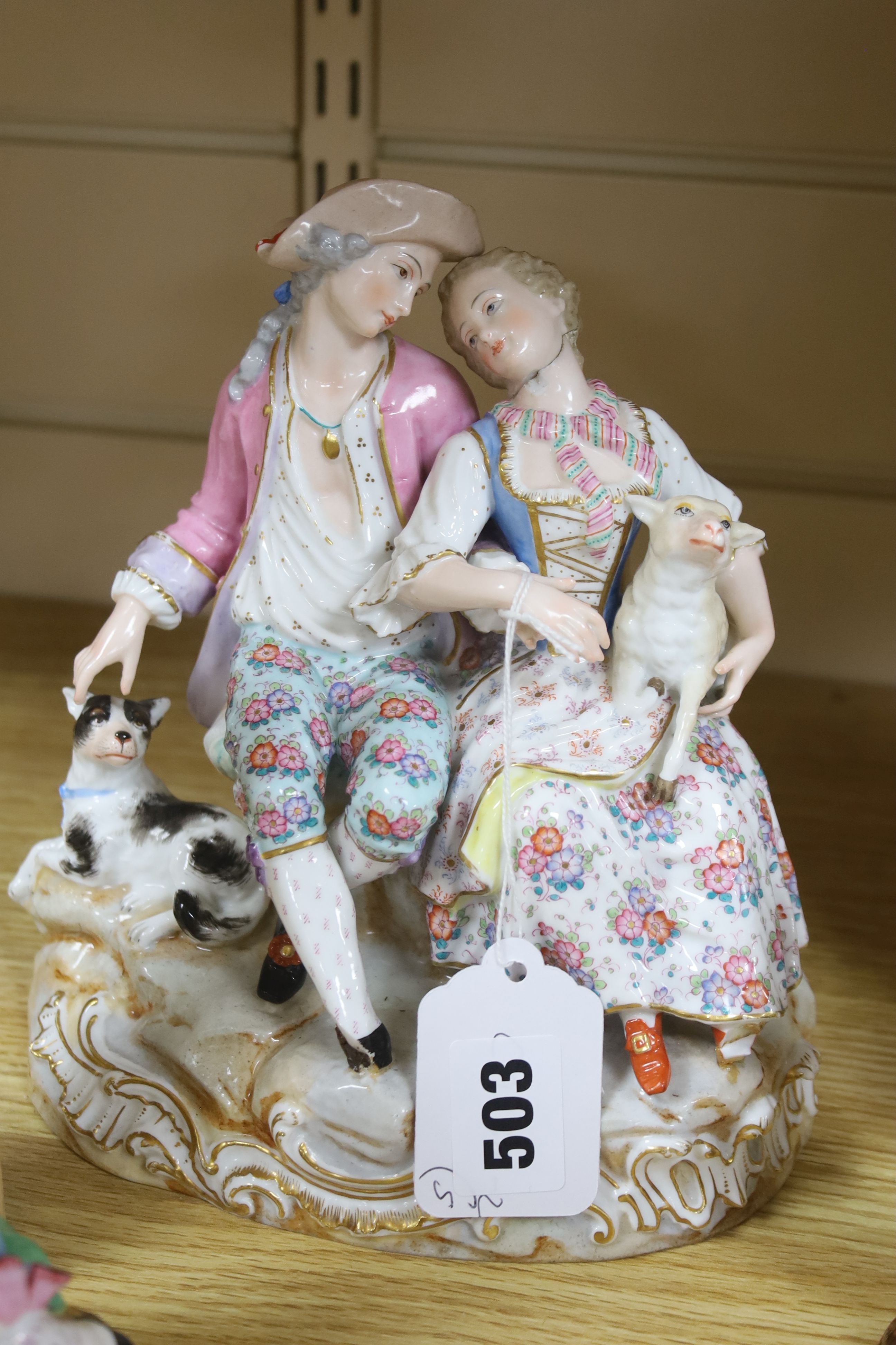 A pair of Meissen style porcelain groups and three other figures, tallest 26cm